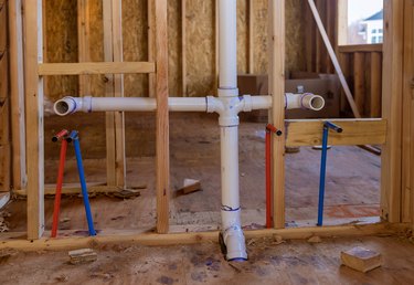 Home construction with hot and cold blue and red pex pipe layout in pipes new bathtub house PVC waste water system