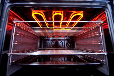 Empty hot oven with a flaming grill close-up.