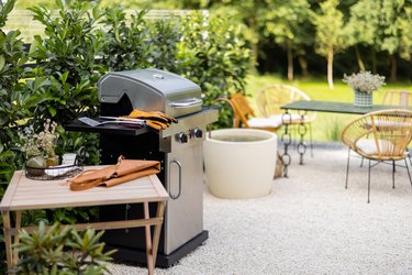 Backyard with barbeque grill and dining table.