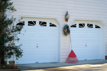 Rake and wreath between two garage doors