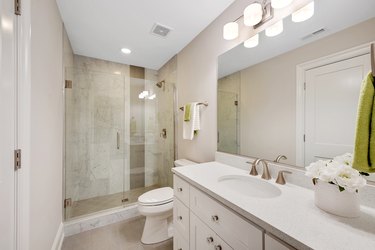 Bright bathroom with glass shower.