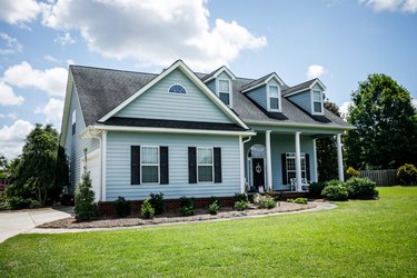 Front View of blue house with siding in the suburbs