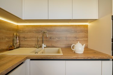 Modern white and beige wooden kitchen interior details
