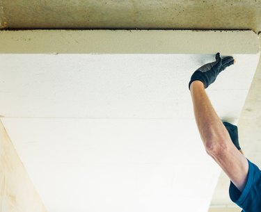 man working with foam plastic