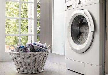 Laundry room with washing machine and laundry basket