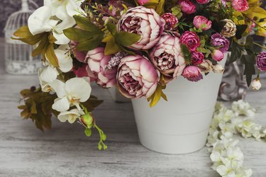 Paper and textile artificial flowers in a decorative bouquet.