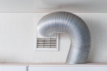 ventilation hood pipe in kitchen in modern apartment. Fan and exhausting system