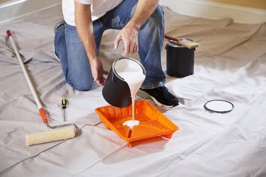 Man pouring paint into tray
