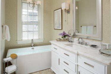 Small bathroom with tub and vanity combining vintage and modern styles