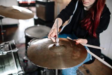 Drummer Adjusting Cymbal