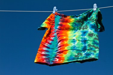 Tie-dye T-shirt hanging on clothes line.