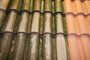 Old and new roof tiles side by side clean and dirty