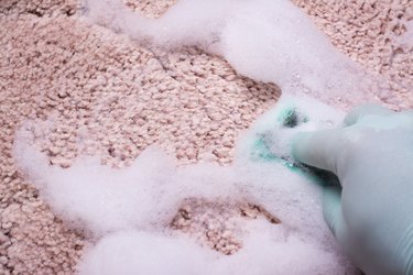 Hand washing pink carpeting.