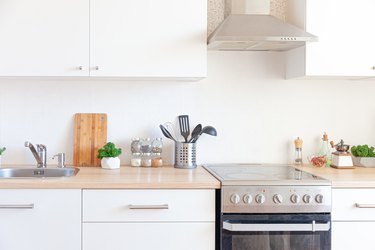 Scandinavian classic minimalistic kitchen with white and wooden details. Modern white kitchen clean contemporary style interior design