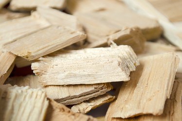 Fuel chips for smoking or heating. Close-up of wood fuel chips, wood chips. Background of small pieces of wood chips for a barbecue or home heating.