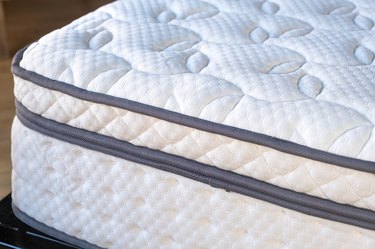 Closeup of mattress on a bed. Home bedroom interior detail, high-angle view .