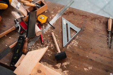carpenter tools,hammer,meter,nails,shavings, and chisel over wood table