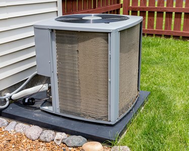 Dirty air conditioning unit before and after cleaning. Condensor coil full of dirt and grass debris. Concept of home air conditioning repair, service, cleaning and maintenance