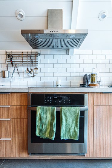 Wide Angle Shot of Green Hand Towels on the Front of a Oven and Range Stove in a Trendy Kitchen