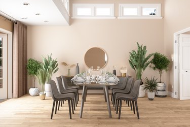 Luxury dining room with houseplants, dining table, and chairs.