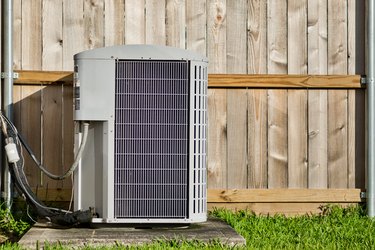 Central air conditioning unit in a residential backyard.