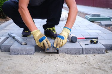 Laying paving stones.