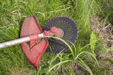 trimmer for cutting grass after work lying on the ground