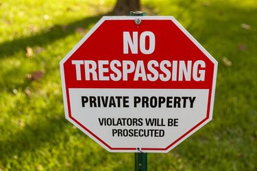 "Private Property, No Trespassing, Violators will be prosecuted" yard sign