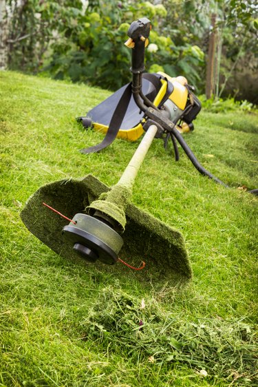 Petrol trimmer on the sloped lawn