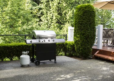 Propane grill on patio.