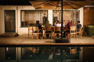 Group of friends enjoying party on patio at night