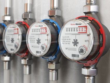 Row of water meters of cold and hot water on wall.