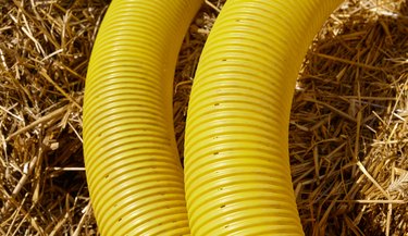Close up picture of perforated yellow land drainage pipe.