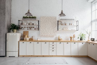 Rustic kitchen interior with white brick wall.