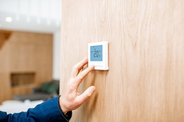 Adjusting temperature with thermostat at home