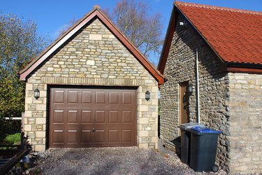 Image of detached garage, up-and-over garage door, bungalow back-door, wheelie-bins