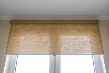 Roller blinds made of thin bamboo on a window
