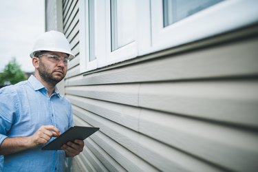 Professional building inspector at work on residential building