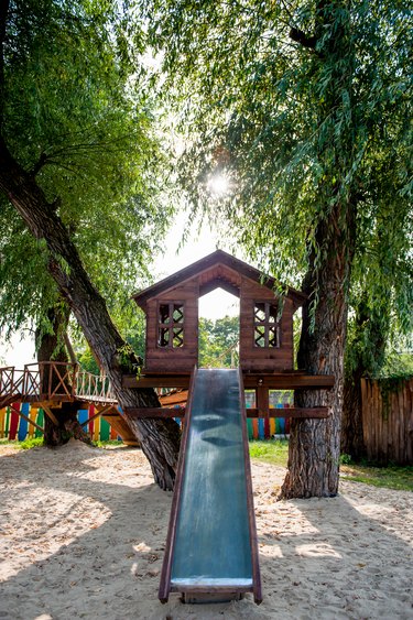 tree house with a slide on the playground