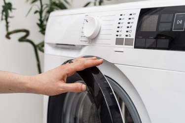 Washing laundry using modern automatic machine.