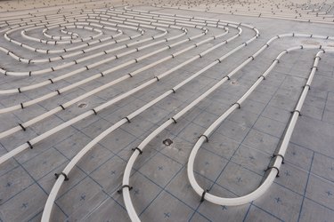 Underfloor heating system installation. Close up on water floor heating system interior of a new indoor swimming pool and SPA center. Plumbing pipes. Individual Heating.