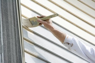 Painter performing trim work in house