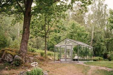 Glass greenhouse in garden