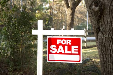 Home for sale with real estate sign.  Front Yard.