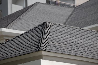 roof shingle background and texture. dark asphalt tiles on the roof.