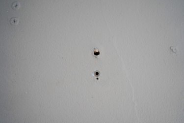 Small drill holes in a wall