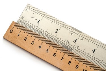 Metal And Wooden Rulers On A White Background
