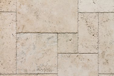 Beige travertine tiles connected together to form a surface.