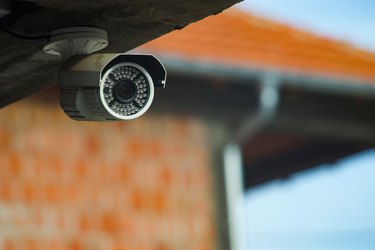 Surveillance security camera under the concrete wall of the building