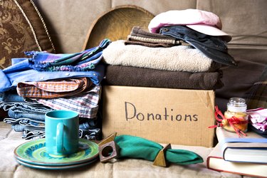 Gathering items to be donated to charity.  Items are placed on a futon that will also be donated.